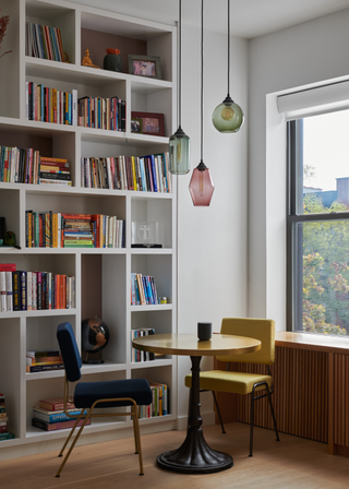 A small dining nook beside a home library