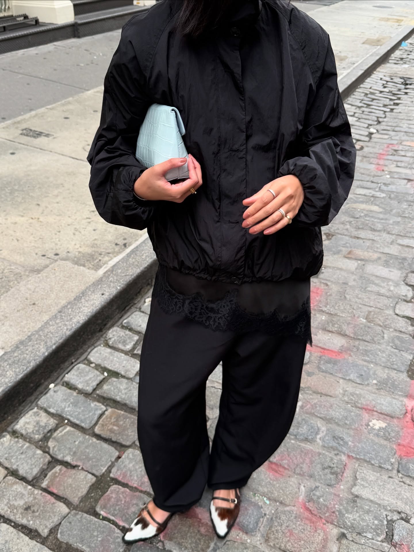 An influencer wearing a black trousers outfit.