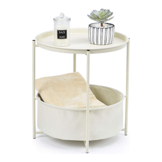 A white side table with a bottom tier fabric basket