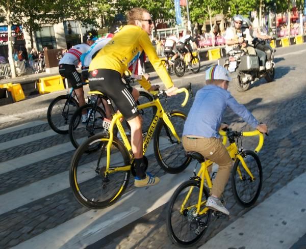 Enjoying the parade lap of the Champs Elysees with his son on a matching yellow Pinarello, and yellow Adidas shoes