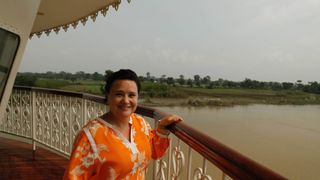 Susan on location in Susan Calman's Cruise of a lifetime wearing an orange top