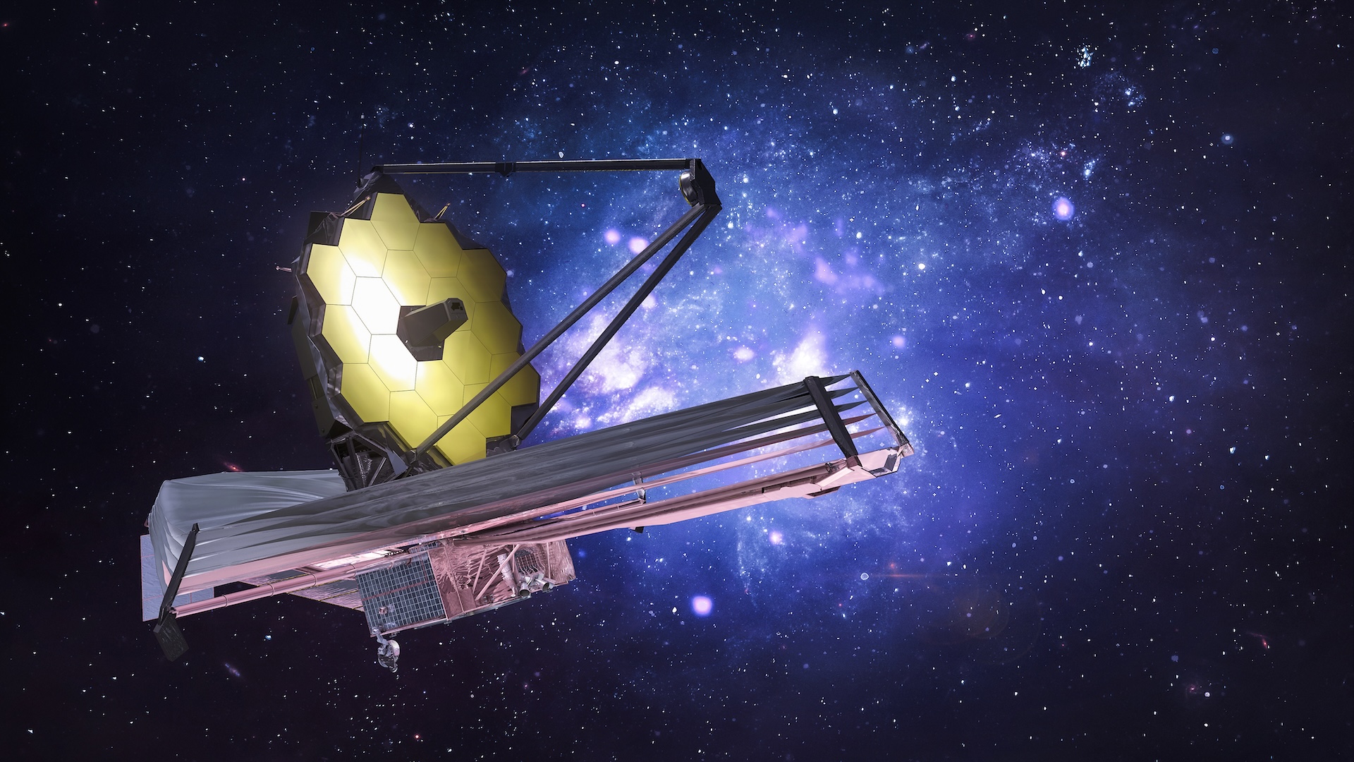 Image of the James Webb Space Telescope placed in front of a star-filled blue and black background. 