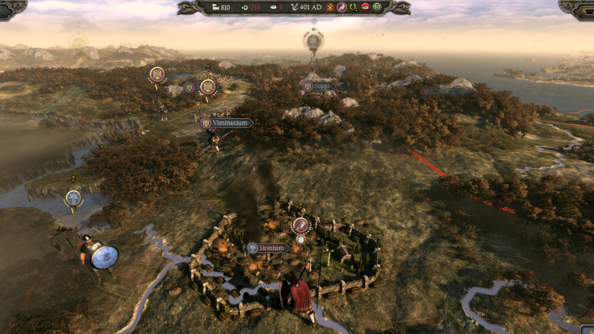 An overview of a game map showing a city on fire during one of the best Total War games, Total War: Attila.