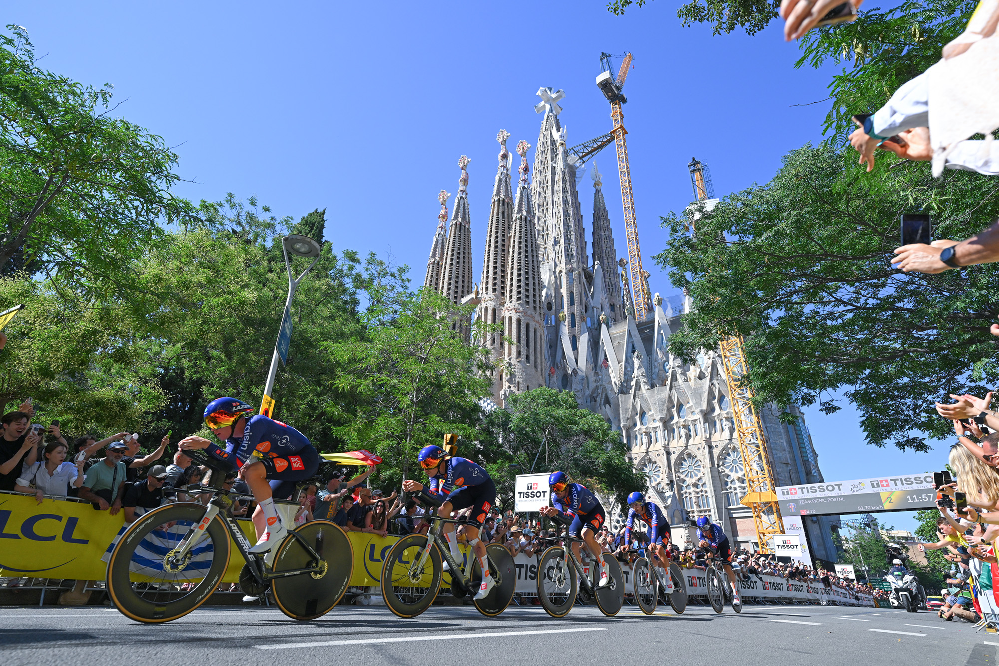Picnic-PostNL race past the Sagrada Familia church in Barcelona during the stage 1 team time trial at the 2026 Tour de France