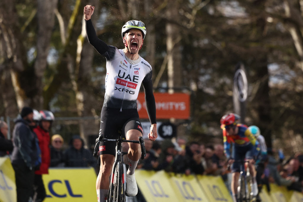 UAE Team Emirates XRG's Portuguese rider Joao Almeida celebrates after crossing the finish line to win the 4th stage of the Paris-Nice cycling race, 163,4 km between Vichy and La Loge des Gardes, on March 12, 2025. (Photo by Anne-Christine POUJOULAT / AFP)