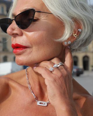 Woman wearing diamond stud earrings.