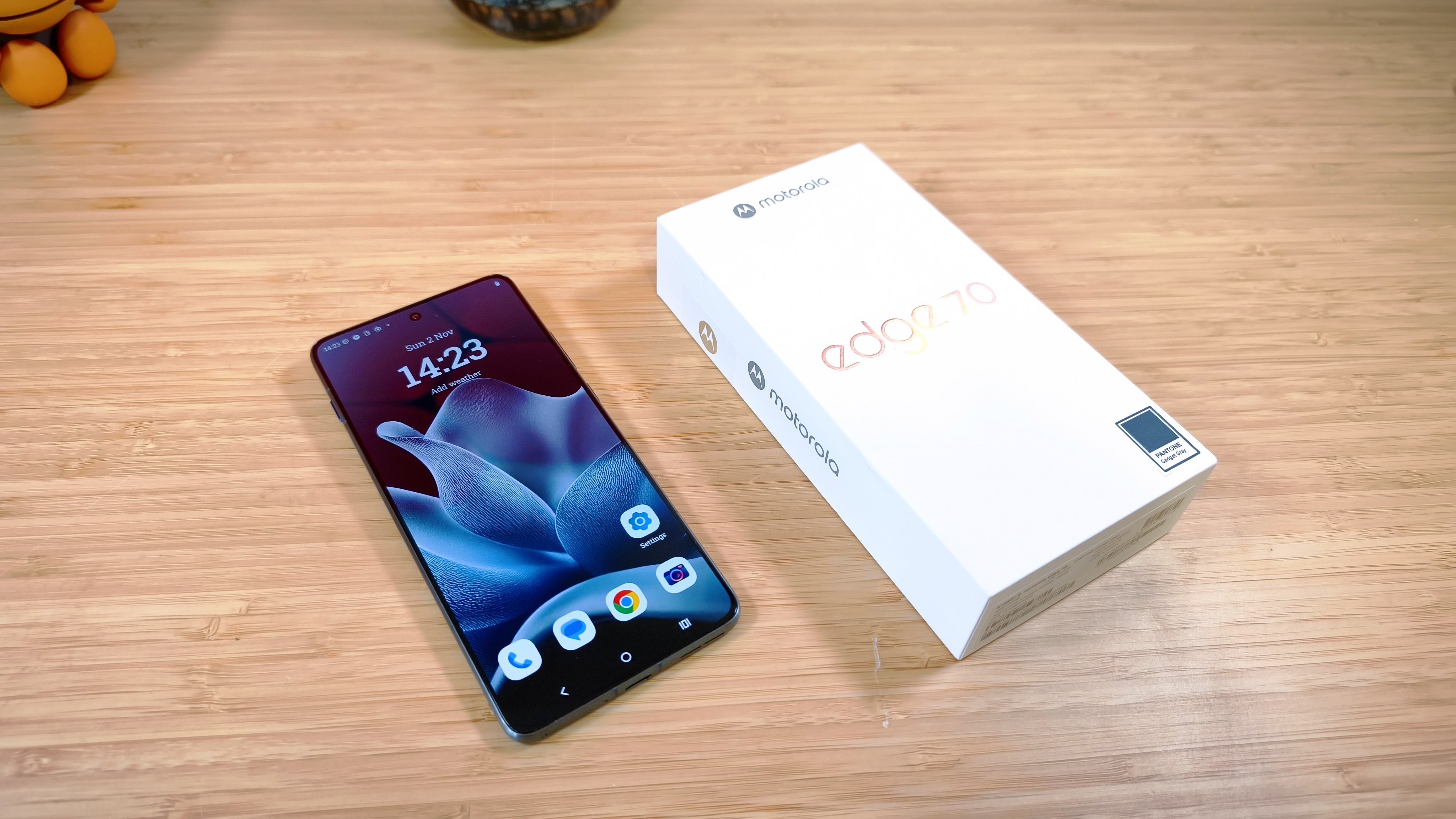 Motorola Edge 70 phone on a wooden desk