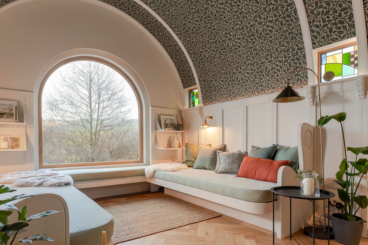 The cream sofa with barrel ceiling and panelled walls