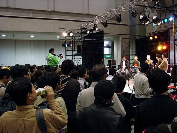 Many spectators crowd in front of the on stage show.