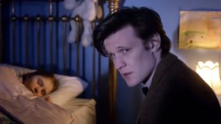 Matt Smith sitting by a bed as the 10th Doctor.