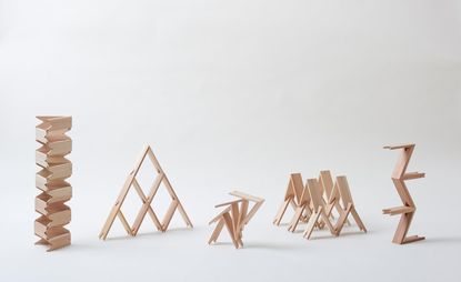 Display of 5 wooden building block creations in an architectural style.
