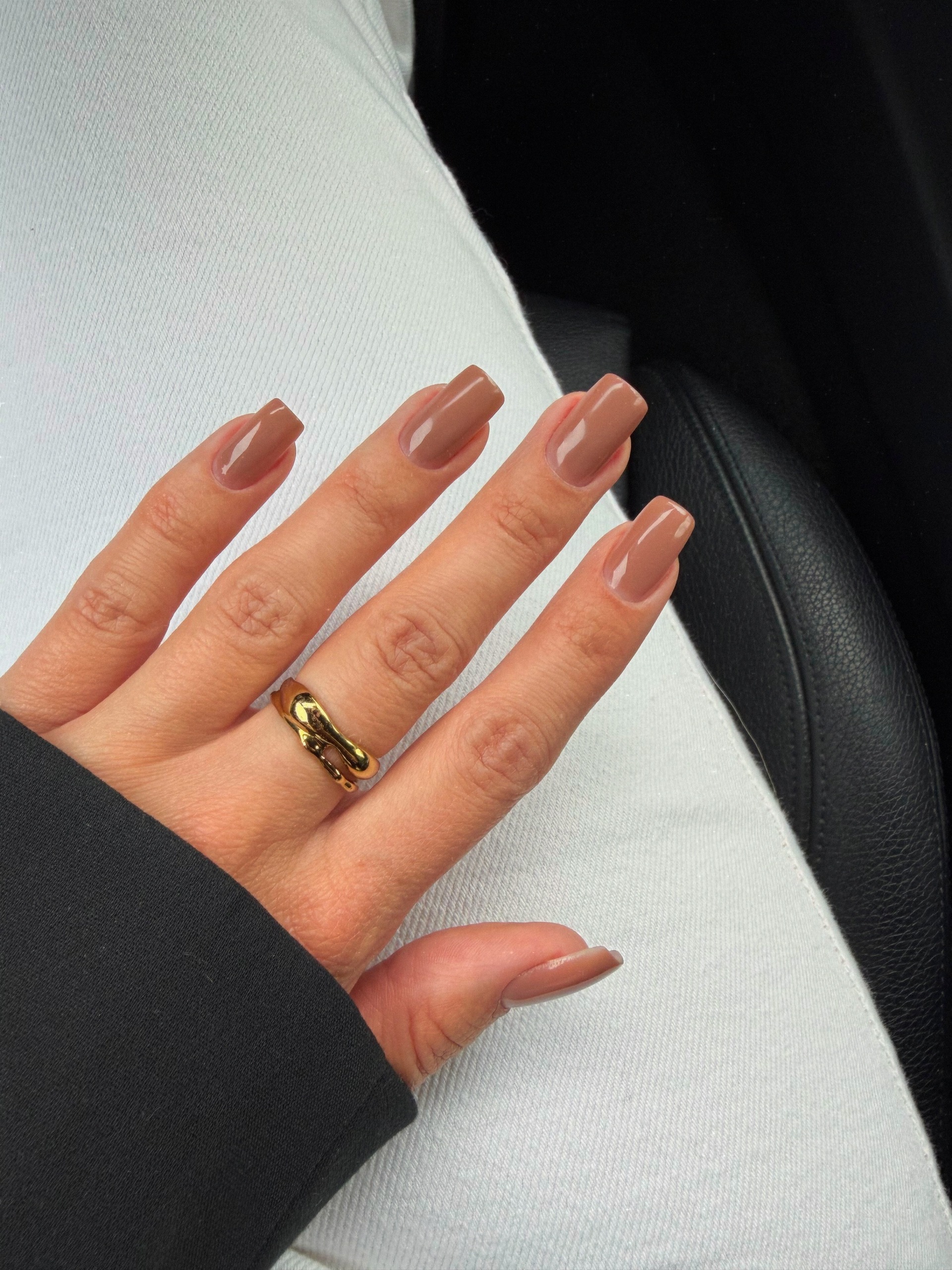 warm caramel nude nails with a little gold ring, very clean and understated