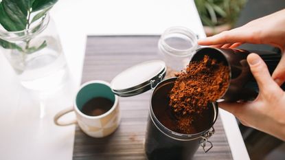 An example of how to store coffee grounds - pouring coffee into a sealable jar