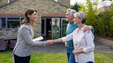 A retired couple meet with a retirement housing navigator.