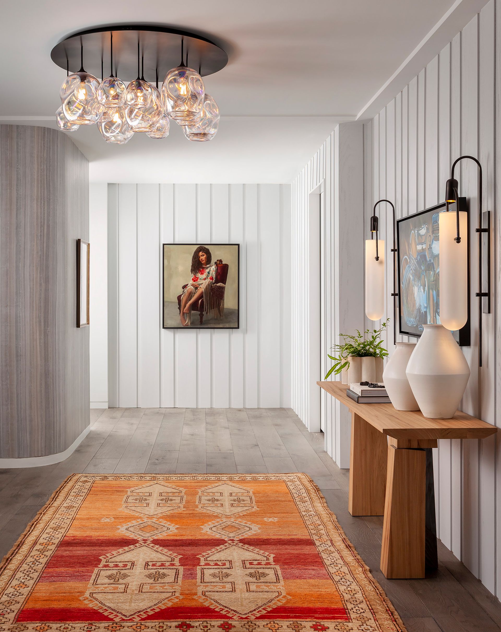 an apartment entryway with a layered lighting scheme
