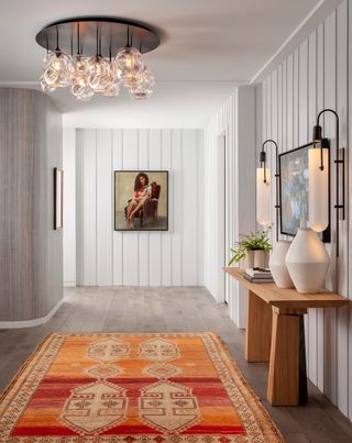 an apartment entryway with a layered lighting scheme