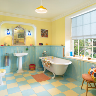 windsor garden bathroom. Freestanding bath and sink with blue and yellow theme