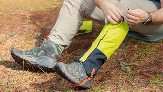 5 reasons you need gaiters: person putting gaiters on