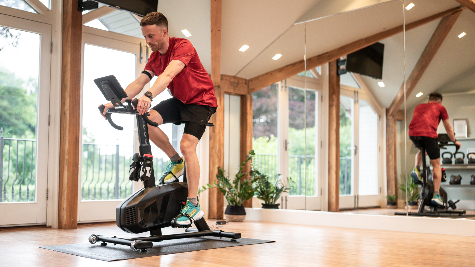 Person riding the Wattbike Proton exercise bike indoors