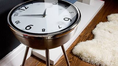 clock table on wooden floor and white carpet
