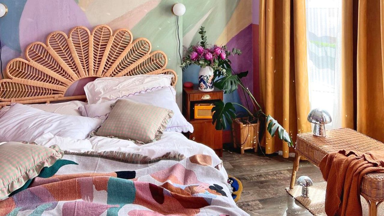 A colorful cozy bedroom with a bed, nightstand, and yellow curtains