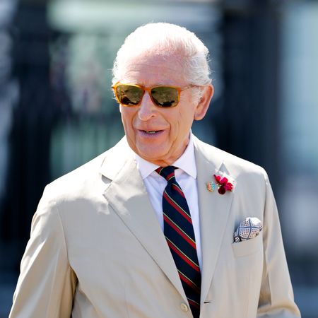 King Charles in a tan suit and sunglasses