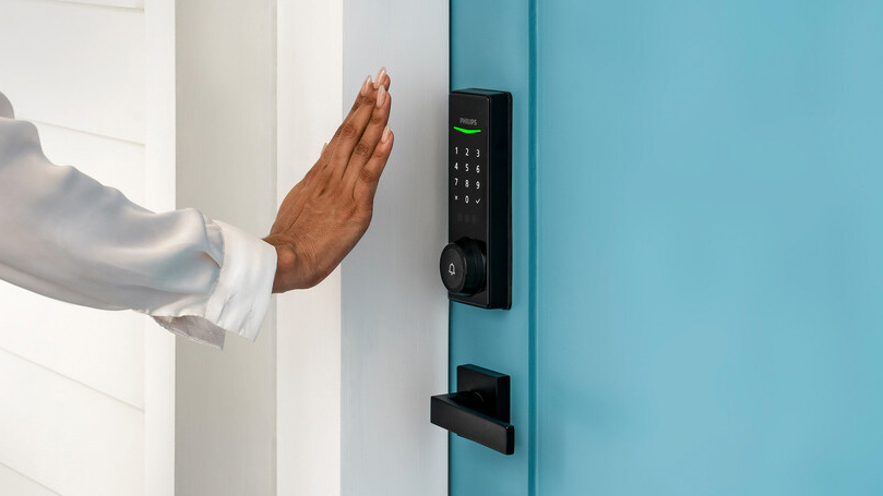 A hand in front of the Philips Wi-Fi Palm Recognition Smart Deadbolt