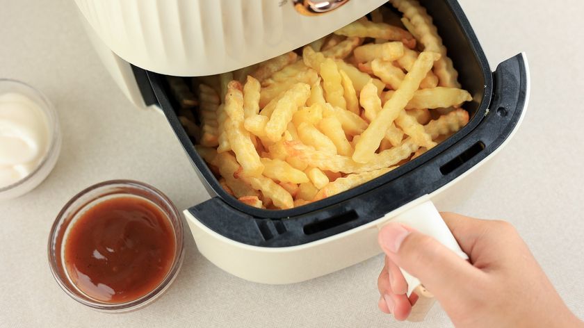 Air fryer full of crinkle-cut fries