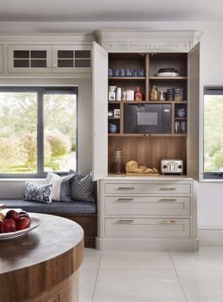 light colored kitchen with breakfast nook and pantry