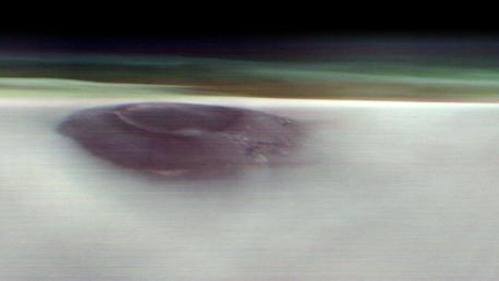 A blurry photo of Arsia Mons towering over the surface of Mars.