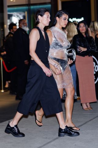 Hayley Kosan and Lauren Chan walking down the street toward the 2024 Sports Illustrated Swimsuit Issue Launch Party.