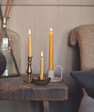 Orange beeswax candles, white and bronze candleholders