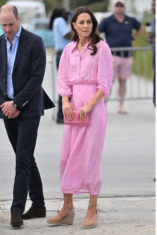 Prince William and Kate Middleton, who wears a pink dress and espadrilles, as they arrive at Daystar Evangelical Church on March 26, 2022 in Great Abaco, Bahamas. Abaco was dramatically hit by Hurricane Dorian which saw winds of up to 185mph and left devastation in its wake. Their Royal Highnesses will learn about the impact of the hurricane and see how communities are still being rebuilt more than two years on. (Photo by Samir Hussein - Pool/WireImage)