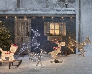 snowy garden scene with shed and reindeer lights
