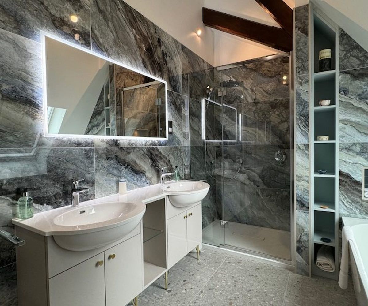 A grey porcelain tiled bathroom and two sinks