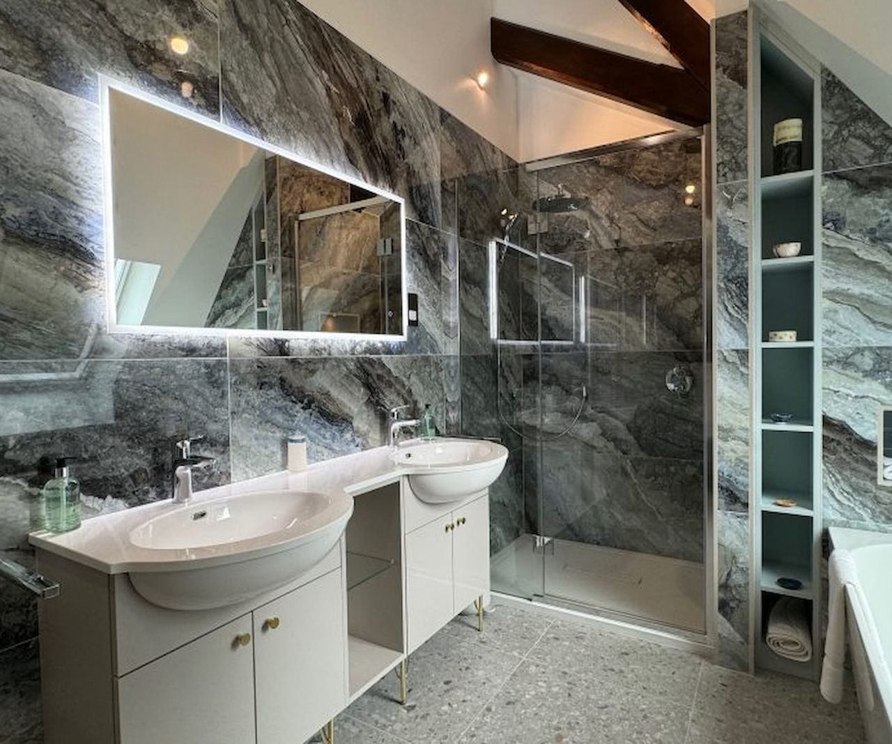 A grey porcelain tiled bathroom and two sinks