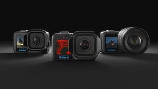 All three of the GoPro Mission 1 series of action cameras side by side over a dark studio background