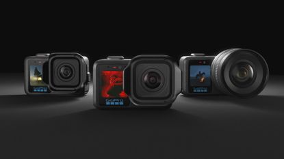 All three of the GoPro Mission 1 series of action cameras side by side over a dark studio background