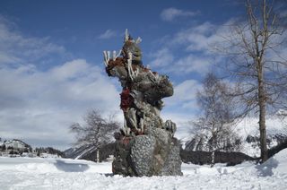 Photograph of Damien Hirst's Two Figures With A Drum sculpture installed in St. Moritz