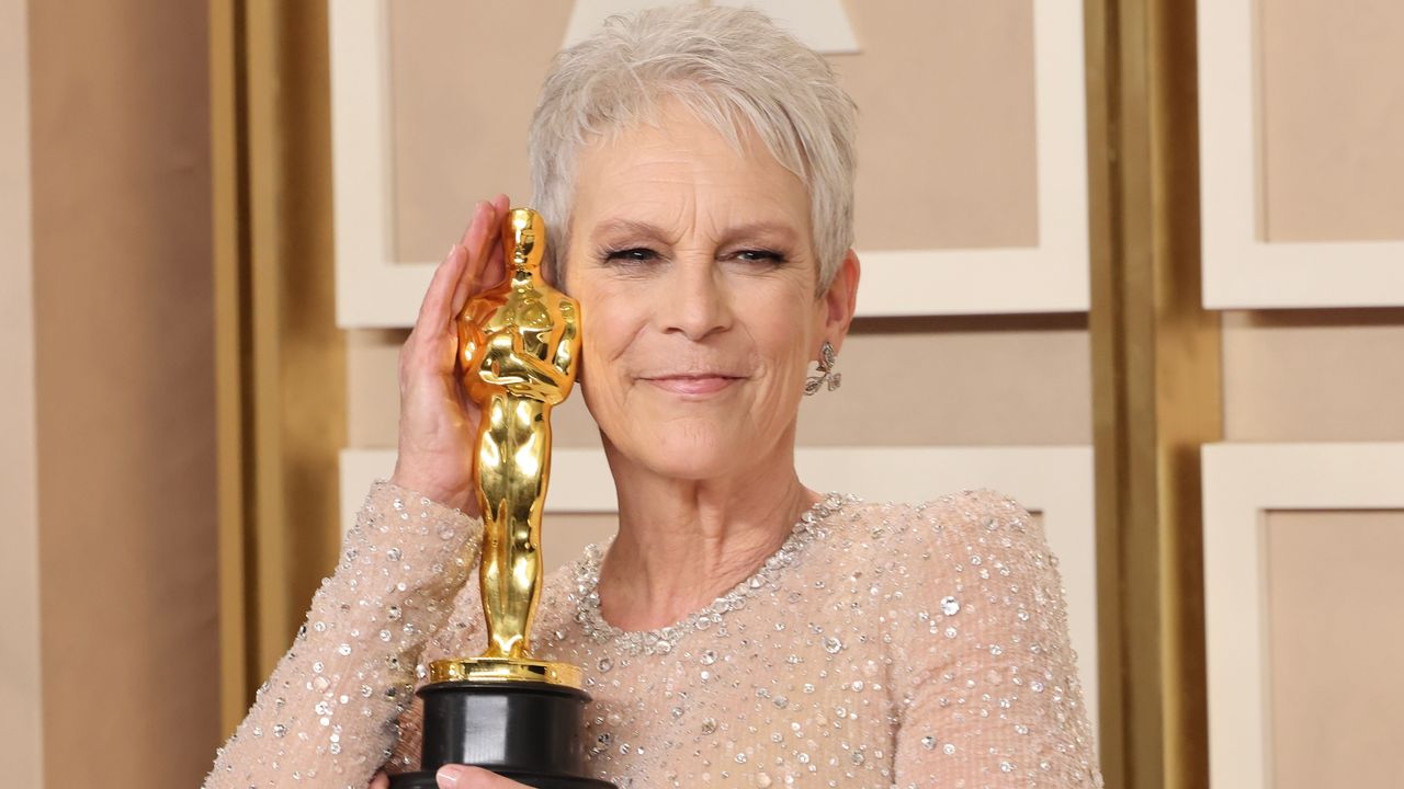 Jamie Lee Curtis&#039; first ever Oscar win for ‘Everything Everywhere All at Once’. Seen here she poses with with Oscar statue