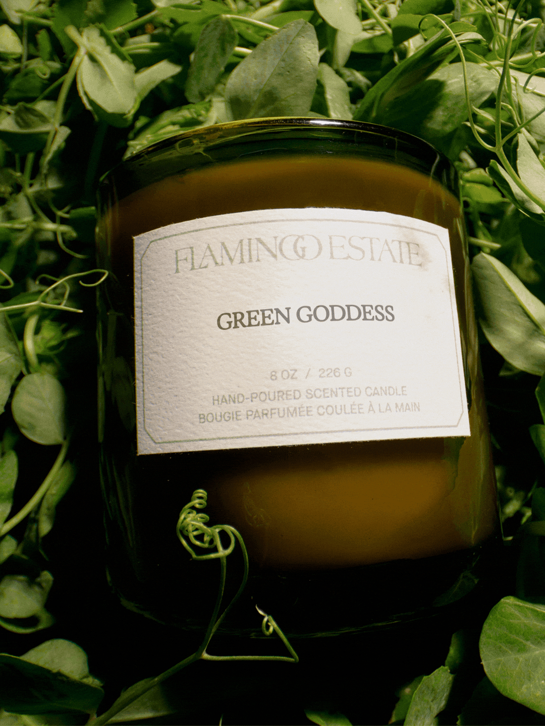 A GIF of a 'green goddess' candle from Flamingo Estate