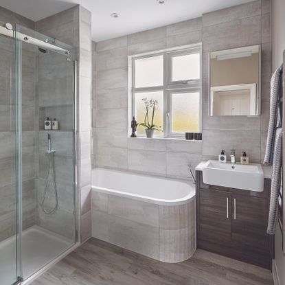 bathroom with grey tiled walls