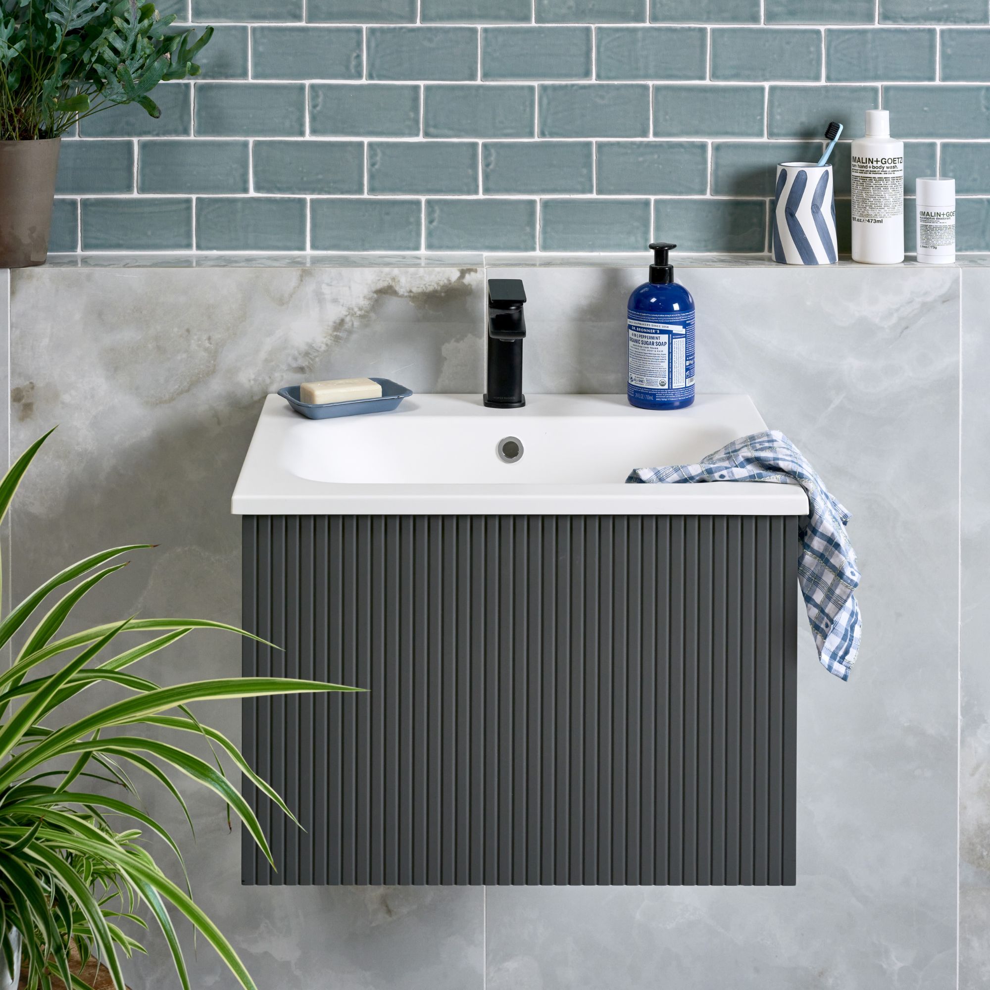 Grey onyx wall behind a bathroom sink