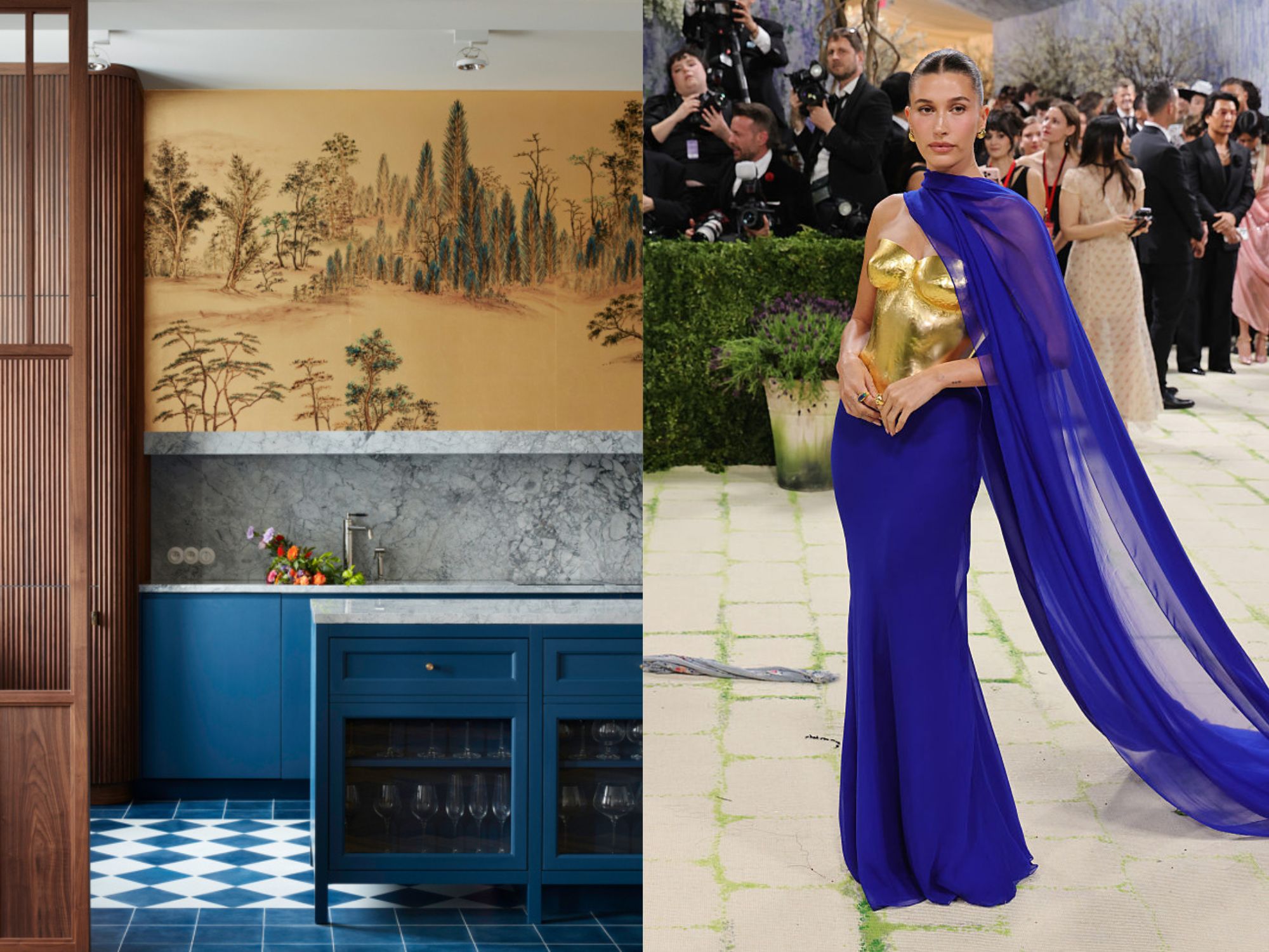 A Blue kitchen with marble splash back and a landscape painting. Hailey Bieber wears a gold bodice with a blue skirt and train.