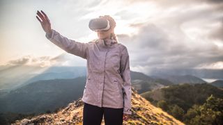 what are ordnance survey maps: woman wearing VR headset on a mountain
