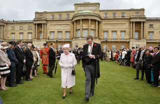 Queen Elizabeth II alongside the Lord Chamberlain, the Earl Peel
