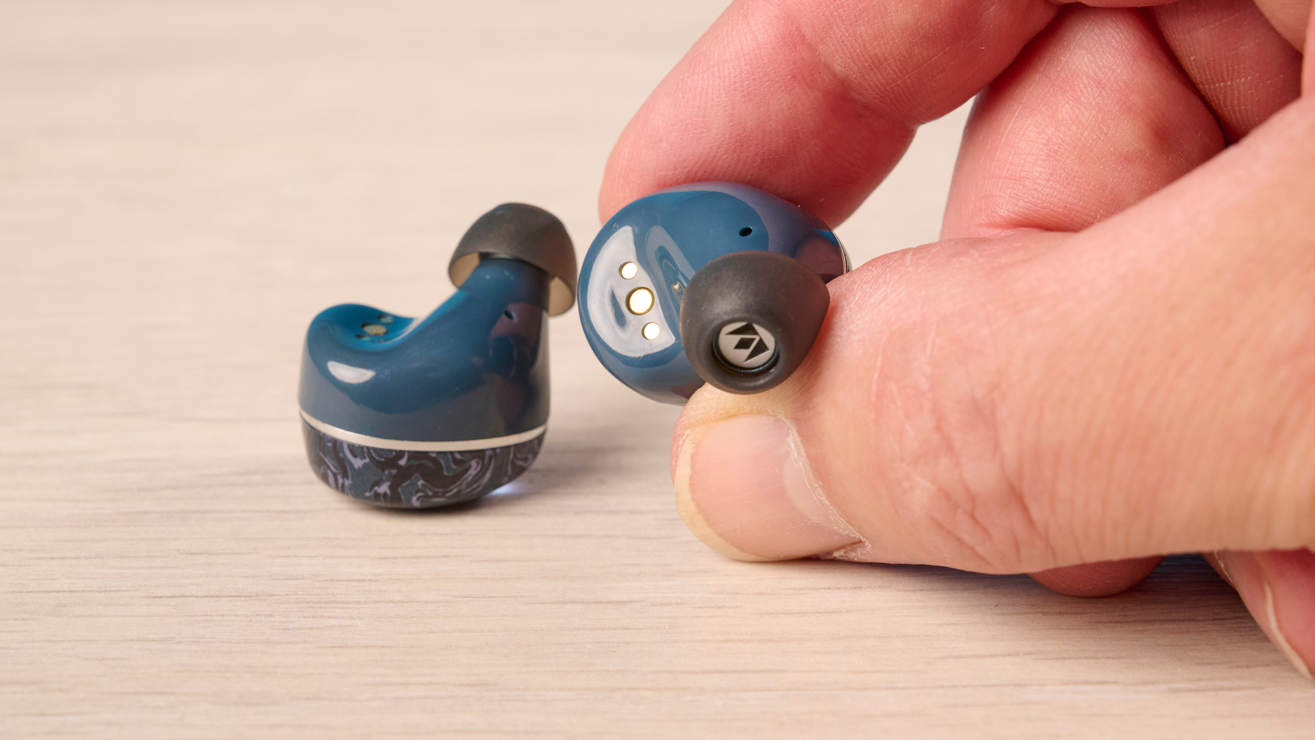 A pair of Noble Audio Osprey wireless earbuds
