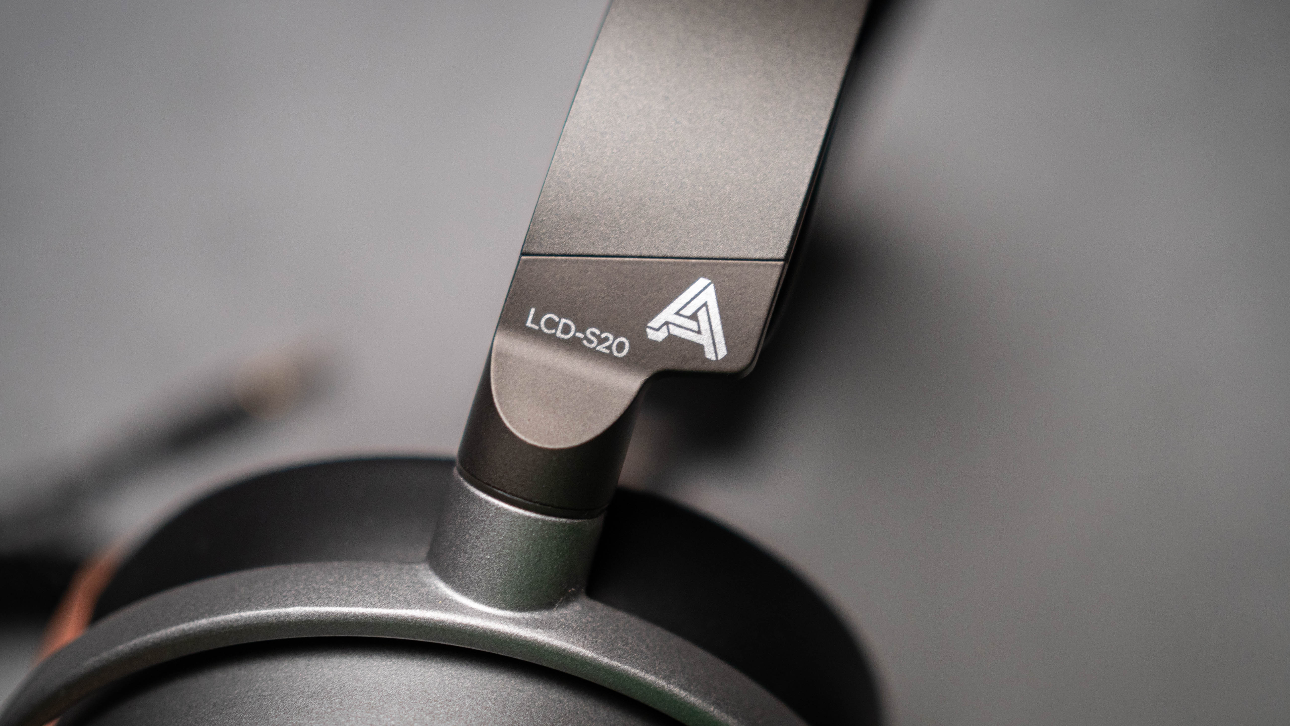 Audeze LCD-S20 planar headset in front of gray kraft sheet highlighting product design
