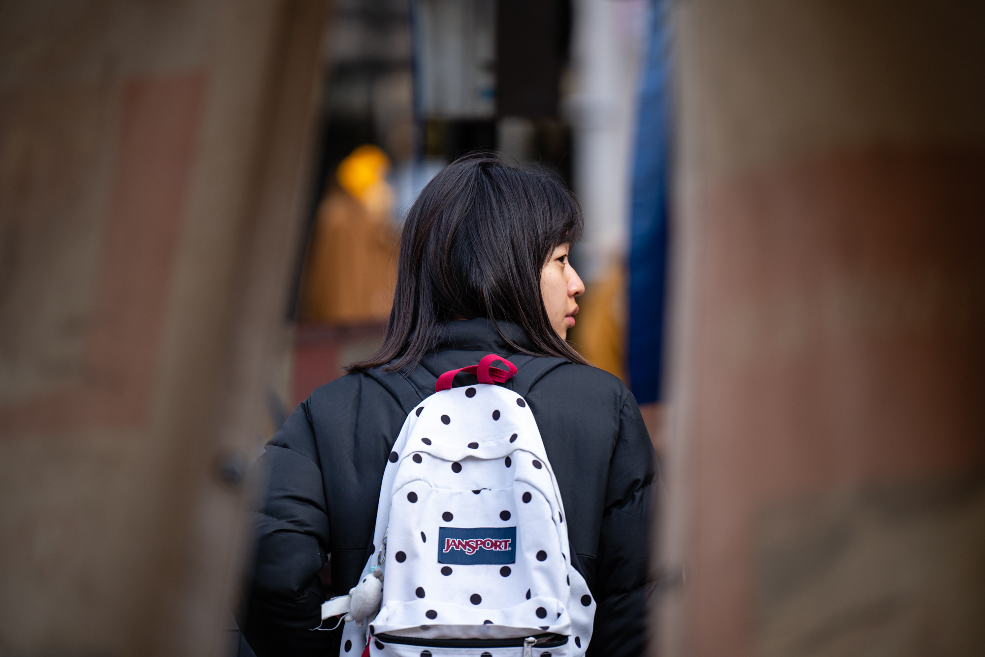 A girl wearing a white backpack