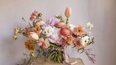 Hand-tied bouquet with peach and pink flowers